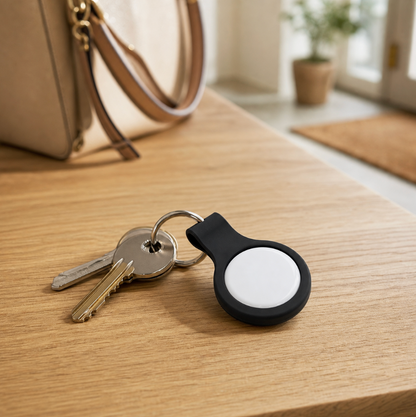 Black silicone keyring holder with white Oscanna Dual Tag attached to house keys