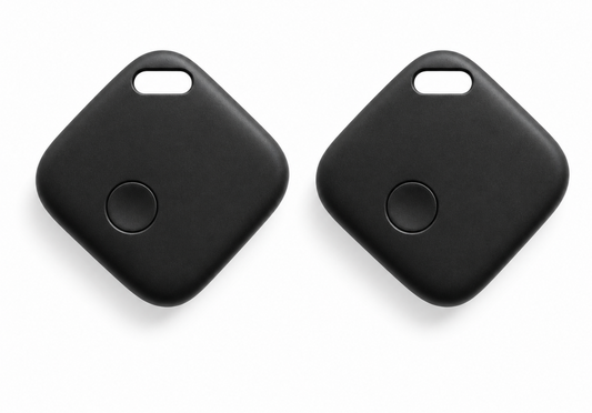 Two black square key finder tags with rounded corners and a small circular button on each, shown on a clean white background.