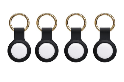 Four white Apple Find My smart tags with silicone keyring holders