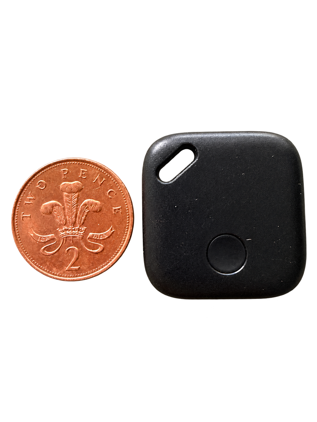 Black mini USB-C rechargeable tracker beside a UK 2p coin for size reference; coin not included