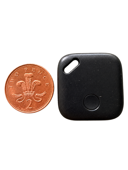 Black mini USB-C rechargeable tracker beside a UK 2p coin for size reference; coin not included
